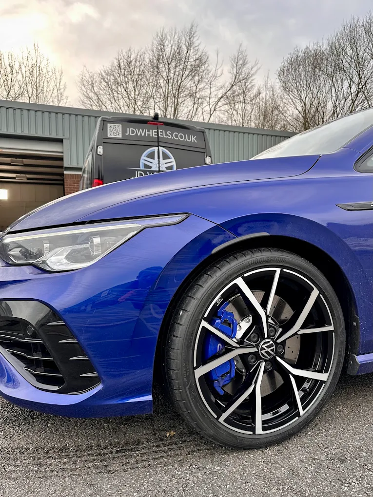 Dark grey refurbished alloy wheel with a machined face fitted to a car